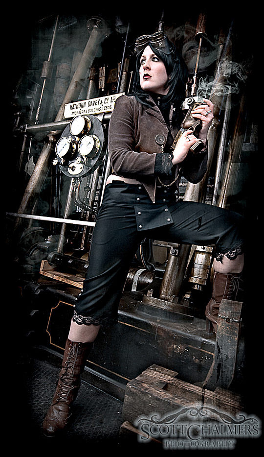 Steampunk model holding a vintage gun that's smoking