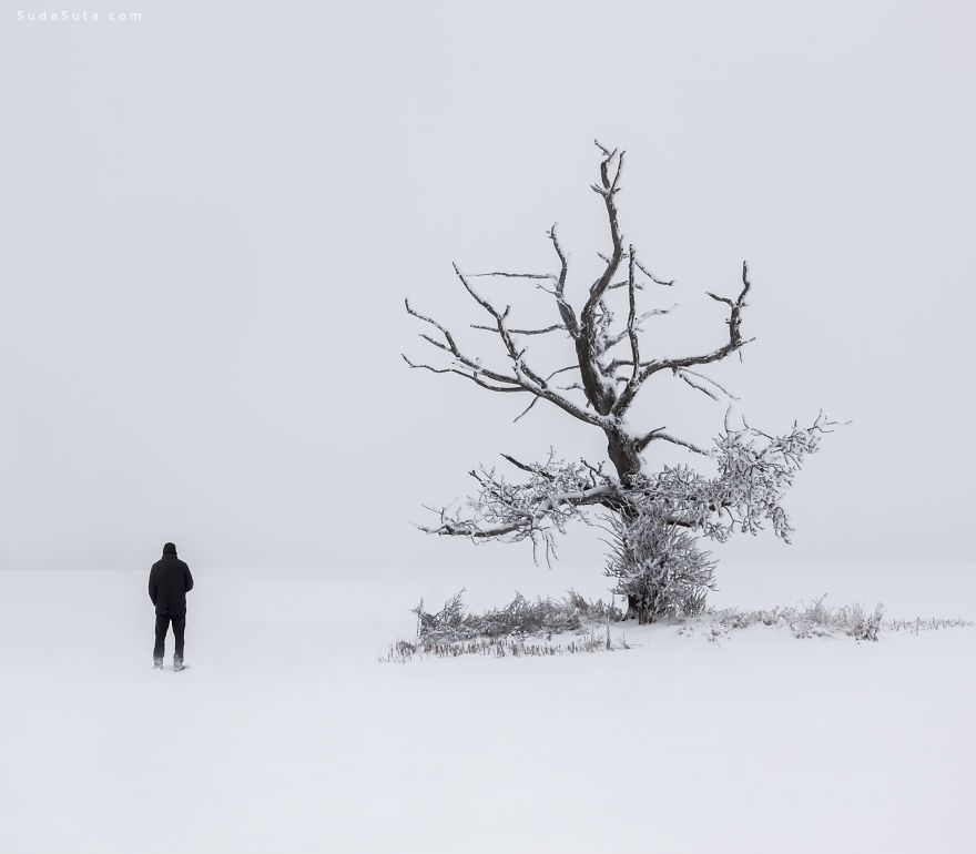 young man standing in winter landscape