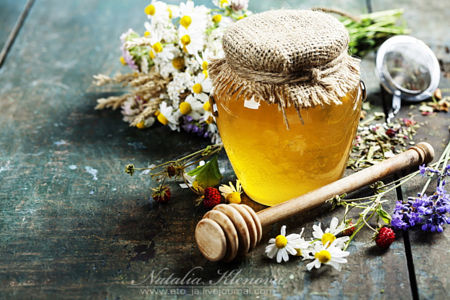 Honey and Herbal tea on wooden background - summer, health and organic food concept